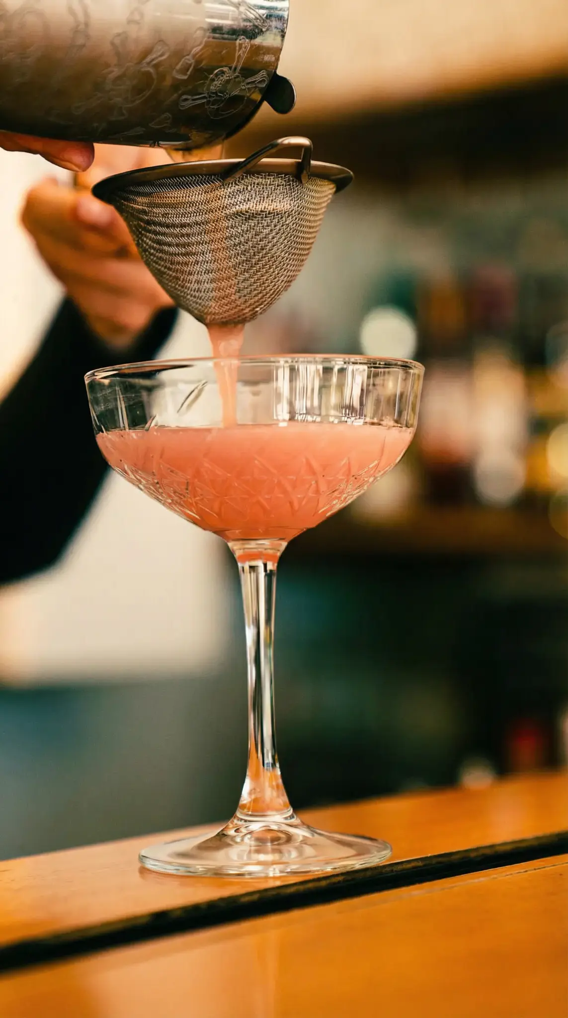 Cocktail being strained at Poppies bar
